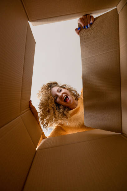istock Surprised young woman unpacking 2190677816