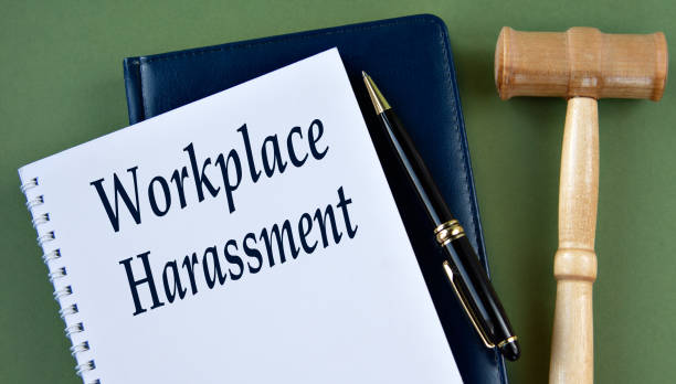 istock WORKPLACE HARASSMENT- words on a white sheet with a judge's gavel 2190682072