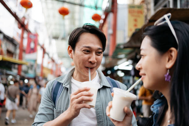 istock Asian couple enjoys refreshing beverages while strolling through the lively ambiance in Chinatown 2190683409
