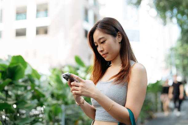 istock Young asian woman finding an E-hailing driver with mobile phone 2190684279