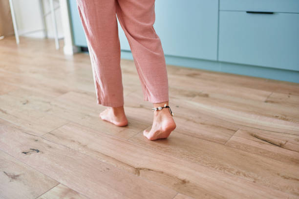 istock Barefoot female legs on comfortable heated warm tiles at home. Modern floor heating system in house 2190684286