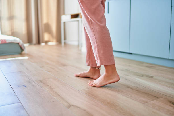 istock Barefoot female legs on comfortable heated warm tiles at home. Modern floor heating system in house 2190684287
