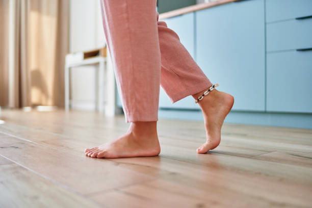 istock Barefoot female legs on comfortable heated warm tiles at home. Modern floor heating system in house 2190684295
