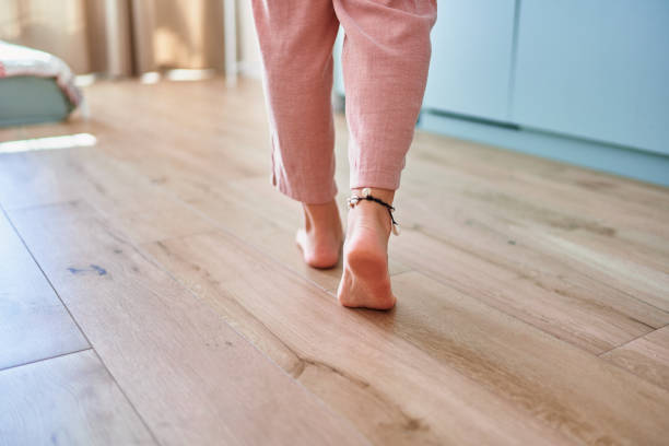 istock Barefoot female legs on comfortable heated warm tiles at home. Modern floor heating system in house 2190684296