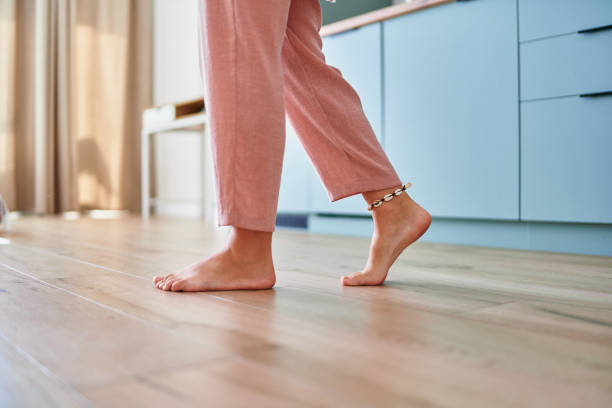 istock Barefoot female legs on comfortable heated warm tiles at home. Modern floor heating system in house 2190684330