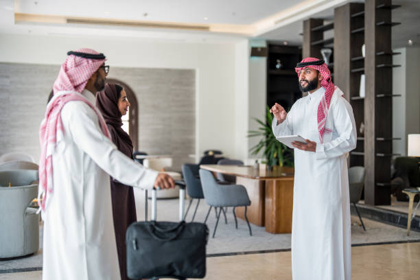 istock Friendly Arabic Hotel Manager Welcomes Couple in Lobby 2190686975