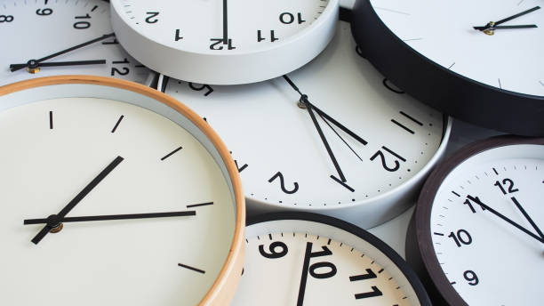 istock A collection of analog clocks overlapping, featuring minimalist white dials with black hands, creating a clean and organized aesthetic. 2190688664