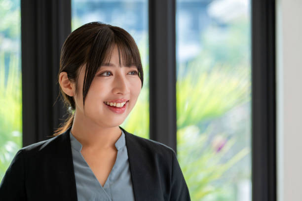istock A Japanese woman smiling by the window 2190691542