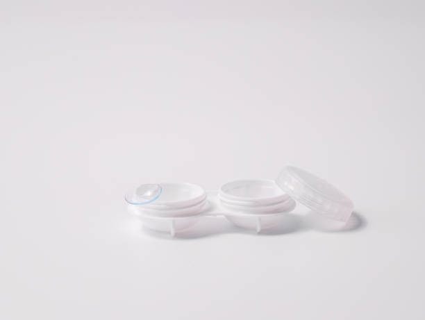 istock White contact lens case with a transparent lens on one side, placed on a clean white background. Minimalist design representing vision correction, hygiene, and eye care essentials 2190691818