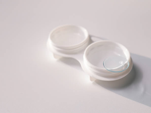 istock White contact lens case with a transparent lens on one side, placed on a clean white background. Minimalist design representing vision correction, hygiene, and eye care essentials 2190691822