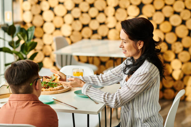 istock Mother and son share a joyful moment over pizza in a cozy cafe setting 2190692501