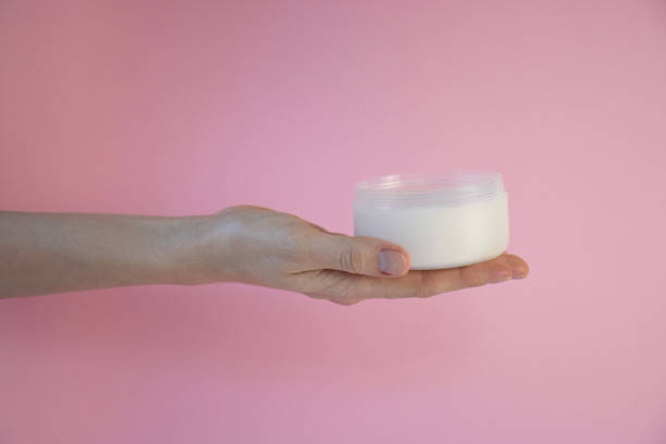 istock Female hands holding a jar of cream. 2190692712
