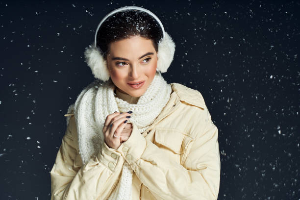 istock Fashion model embraces winter charm in a cozy studio setting with snowflakes 2190694299