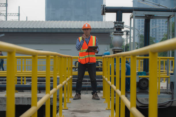 istock Male worker in PPE working on waste water treatment pant 2190694770