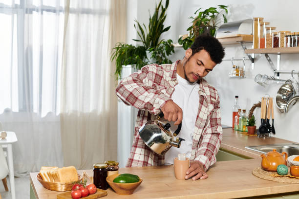 istock Young man enjoys a calm morning while preparing coffee in a stylish apartment kitchen 2190694879