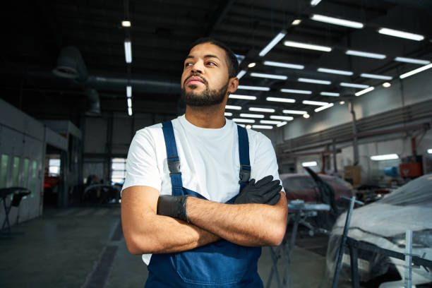 istock Dedicated mechanic confidently working in a bustling auto repair service center 2190695909