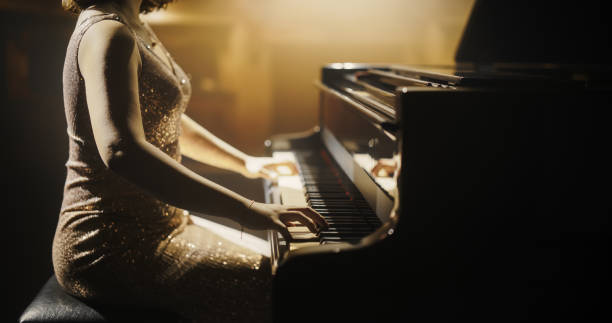 istock Close Up on an Anonymous Pianist Performing Classical Instrumental Music on Stage. Female Musician Using a Grand Piano to Create Beautiful, Melodic Jazz Improvisation. Hands Moving Across the Keys 2190696143