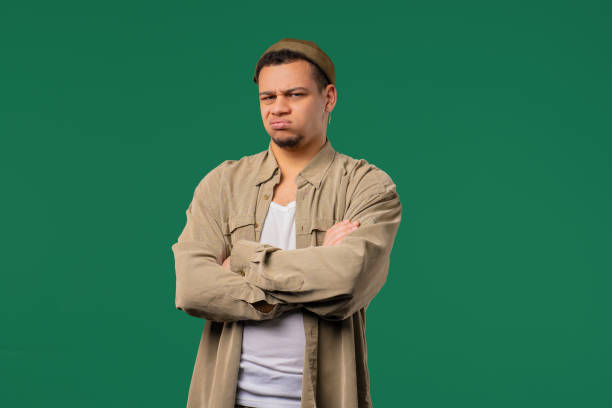 istock Dissatisfied Offended Man Keeping Arms Crossed And Staring At Camera With Sceptical distrustful look, feeling mad at someone. Human facial expressions, emotions and feelings. Body language. 2190696201