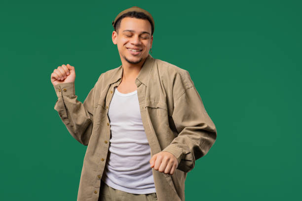 istock Active positive african 30s man dancing, green background. Funny happy guy,great 2190696231