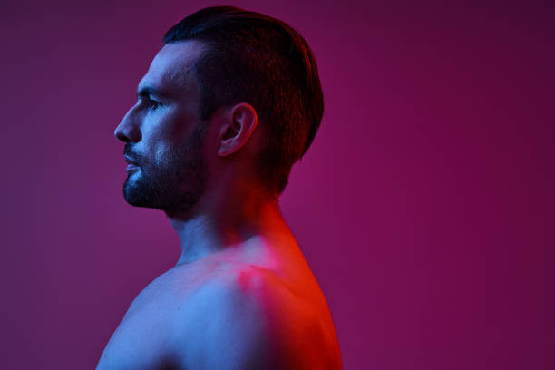 istock Handsome stylish man posing against vibrant lighting for an artistic portrait 2190699558