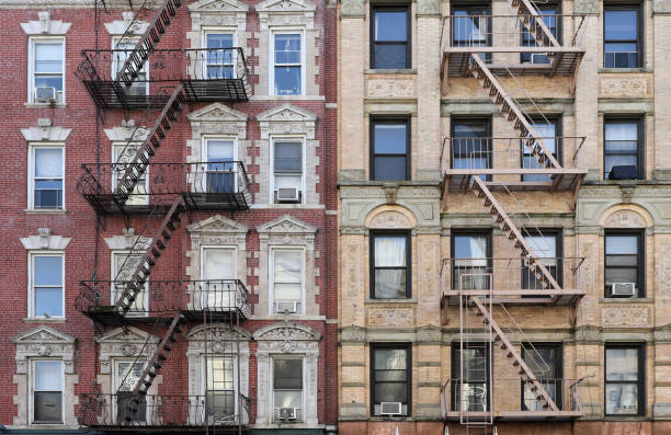 New York City, old apartment building with external fire ladder and ornamental carvings around windows