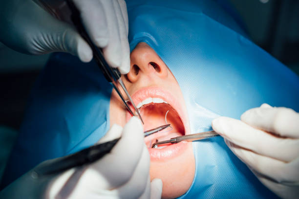istock Dentist working in his office with a patient. 2190700077