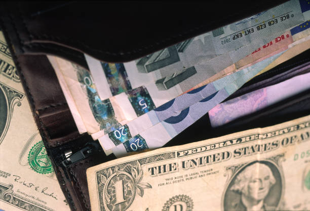 istock Paper dollar and euro bills in an open wallet. 2190700083