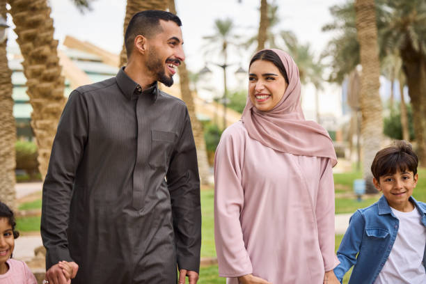 istock Happy couple talking while walking with kids 2190700731