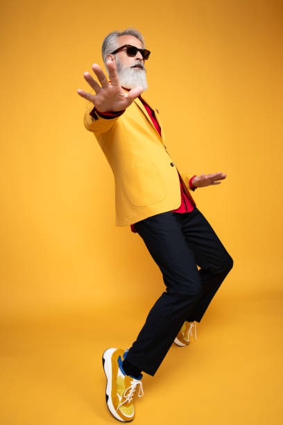 istock Stylish Elderly Man Posing in Yellow Outfit 2190702577