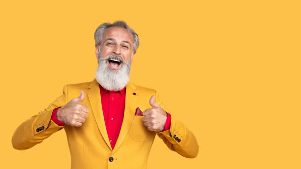 istock Stylish Elderly Man Posing in Yellow Outfit 2190702580