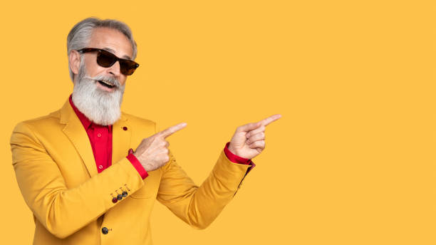 istock Stylish Elderly Man Posing in Yellow Outfit 2190702593