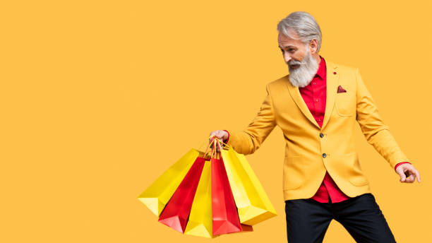 istock Stylish Elderly Man Posing in Yellow Outfit 2190702594