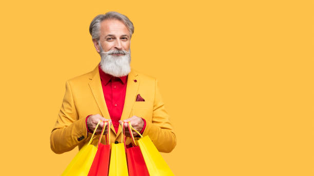 istock Stylish Elderly Man Posing in Yellow Outfit 2190702596