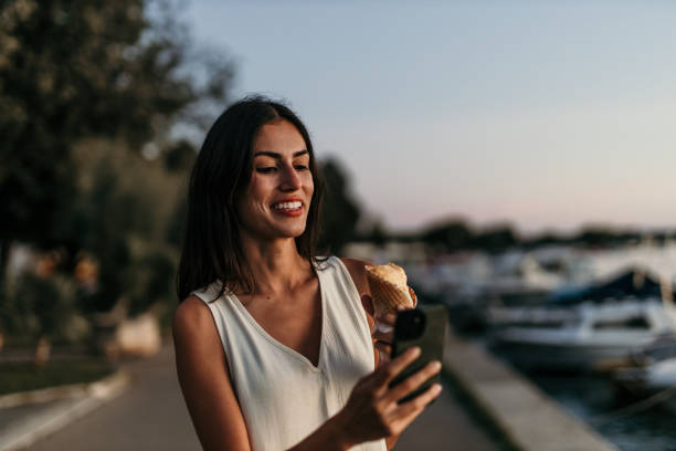 istock Happy woman savoring ice cream 2190703187