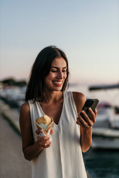 istock Happy woman savoring ice cream 2190703188