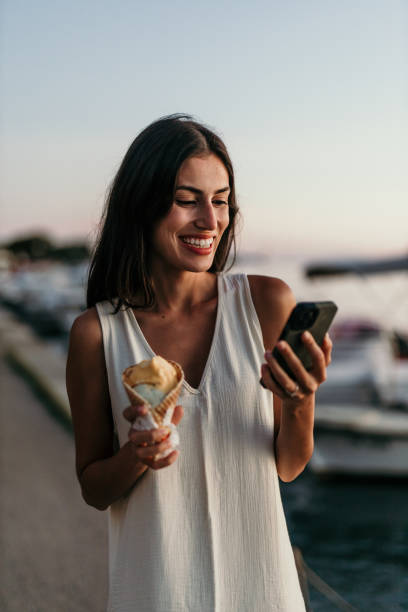 istock Happy woman savoring ice cream 2190703244