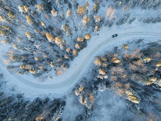 istock Winter road in a snowy forest, top view. 2190703251