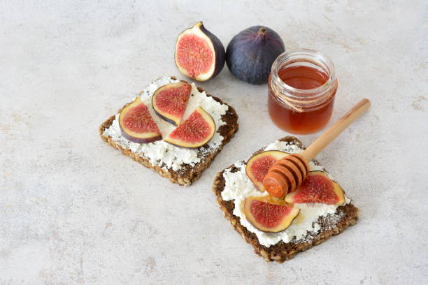 istock toasts with cream cheese and slices of fig fruit flat lay 2190703808