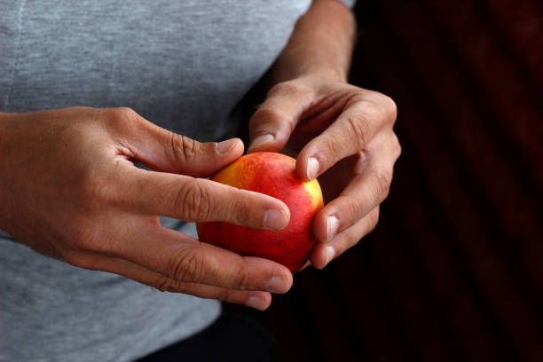 peach in hand, man holding peach in hand
