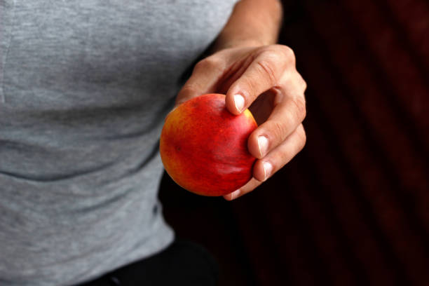 peach in hand, man holding peach in hand
