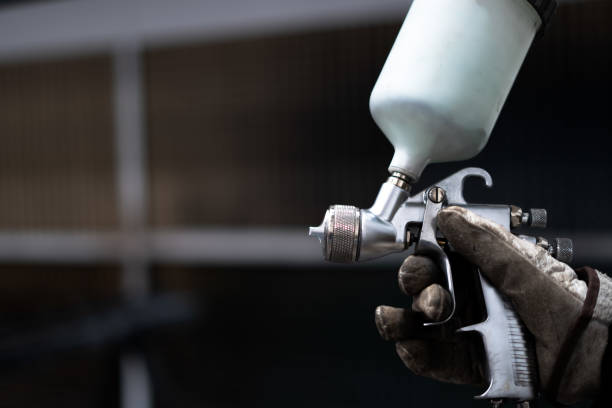 istock hands of a man with a paint gun 2190706213