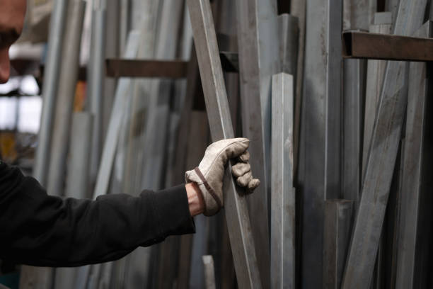 unrecognizable man working in a metal industry taking irons