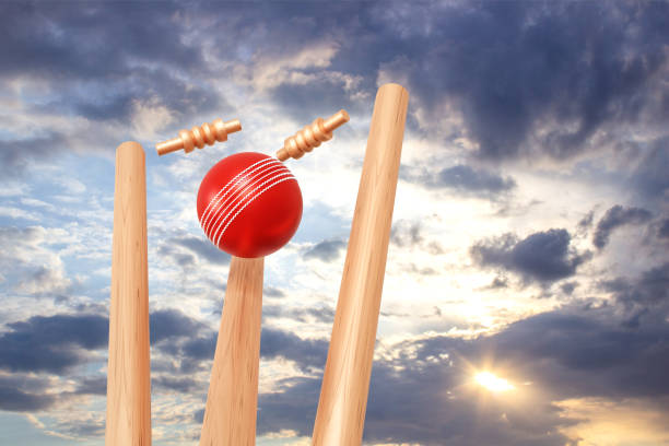 Cricket ball hitting wicket stumps against blue sky background. 3d-rendering