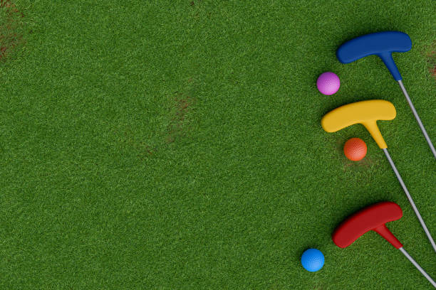 istock Colorful mini golf clubs and balls on green grass. Top view 3d rendering 2190710793