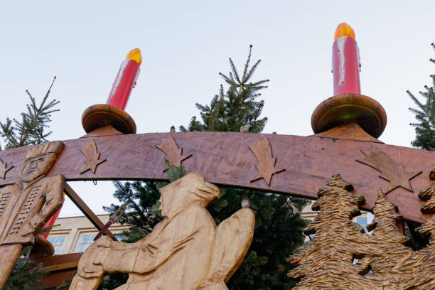 Traditional wooden Christmas decorations featuring red candles and intricately carved figures, creating a festive atmosphere in Berlin, Germany. These decorations are commonly displayed during the holiday season in European cities. Photo taken on December 15, 2019.