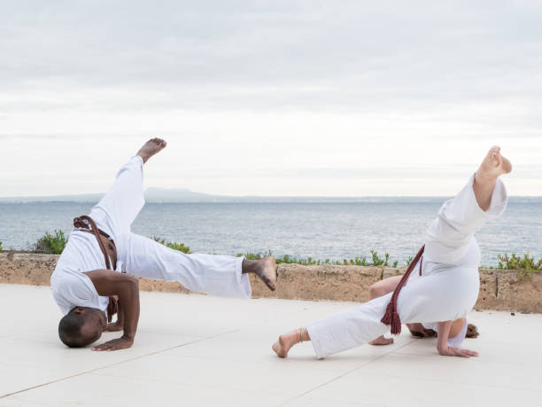 istock Two people practicing capoeira exercise near the ocean 2190712212