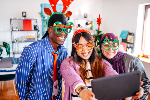 istock Colleagues celebrating new Year together in office while using digital tablet to take a selfie 2190714845