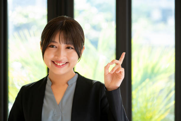 istock A woman pointing her finger by the window 2190714863