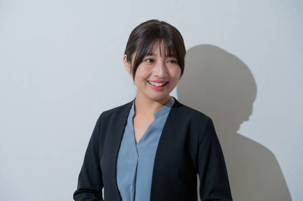 istock A Japanese woman smiling on a white background 2190715166