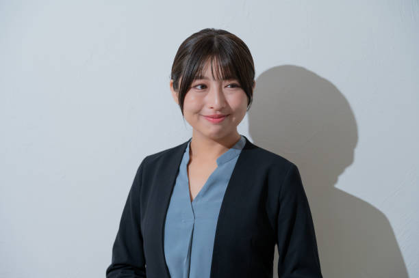 istock A Japanese woman smiling on a white background 2190715175